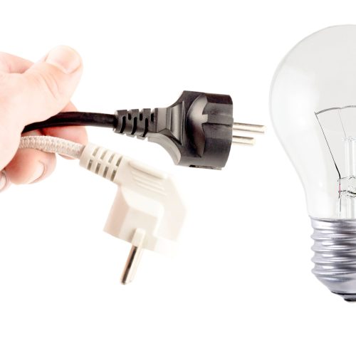 Plug in your hand, incandescent lamp  on a white background